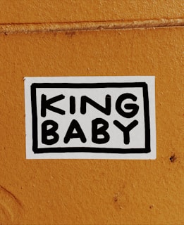 a vinyl sticker that reads 'KING BABY' in bold writing