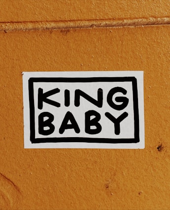 a vinyl sticker that reads 'KING BABY' in bold writing