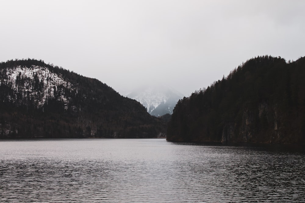 body of water near mountain during daytime