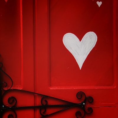 red wooden door with heart shaped white heart shaped