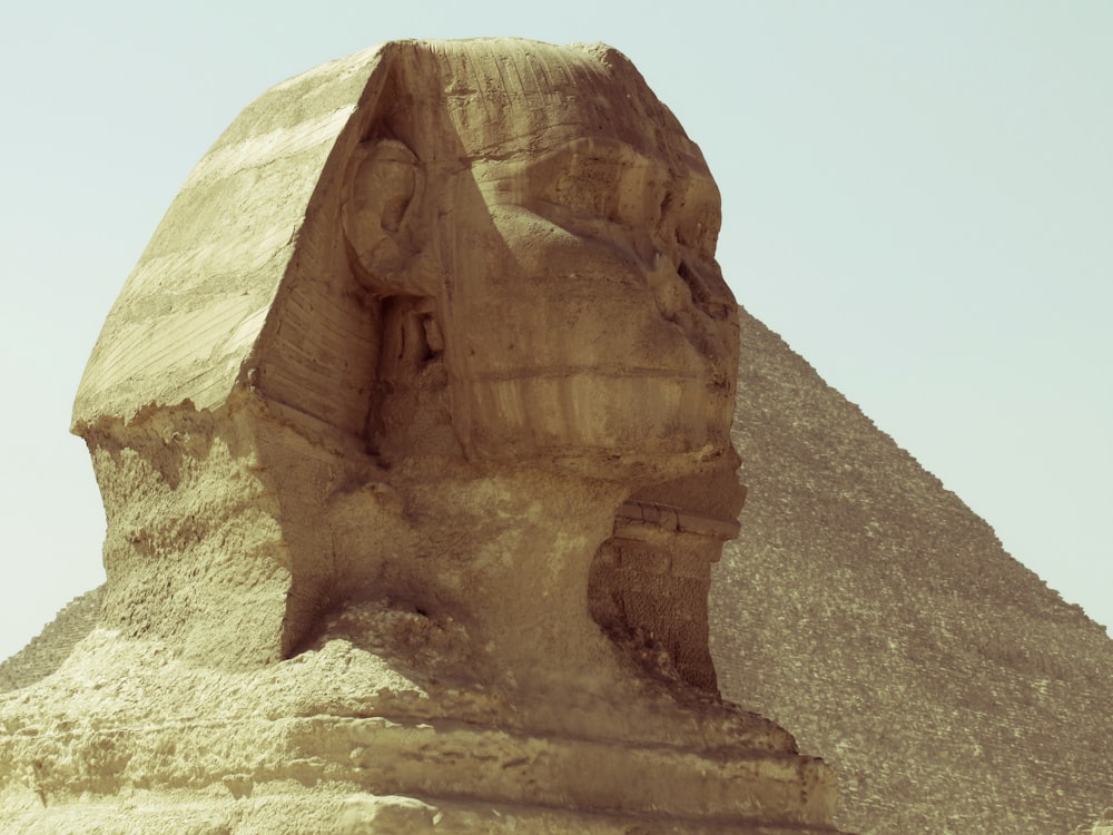 brown rock formation under white sky during daytime