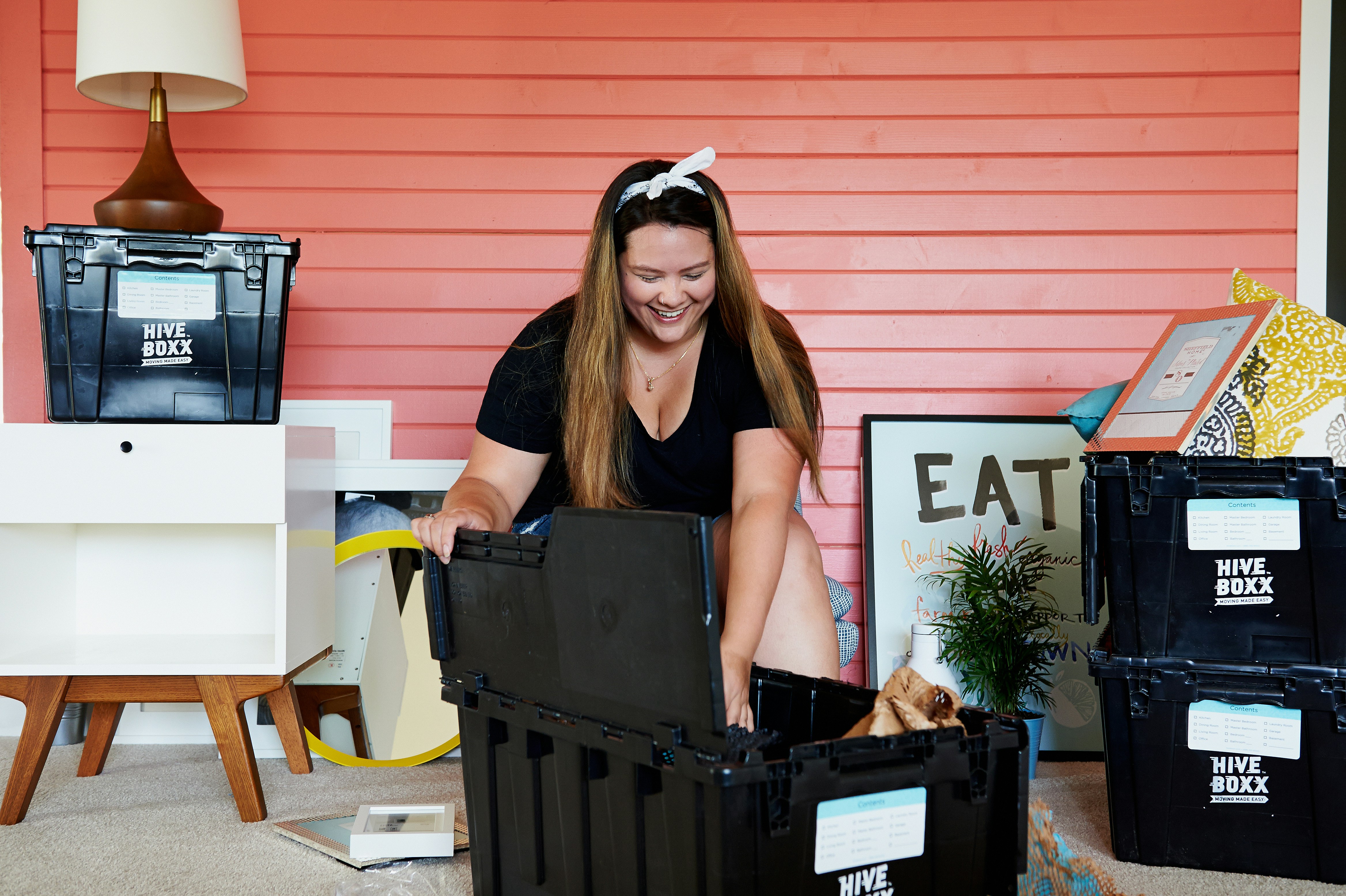 woman in black tank top sitting on black plastic crate