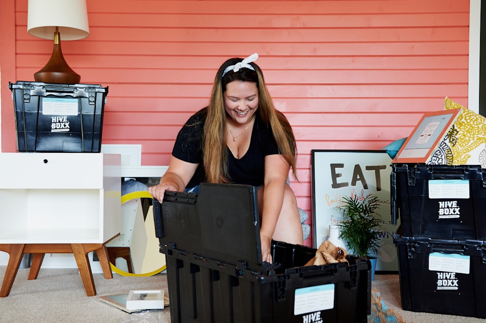 woman in black tank top sitting on black plastic crate