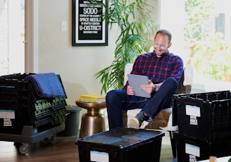 Man reading health articles on a tablet in a cozy living room