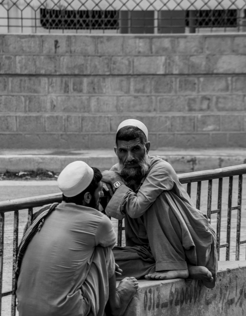 man and woman sitting on bench