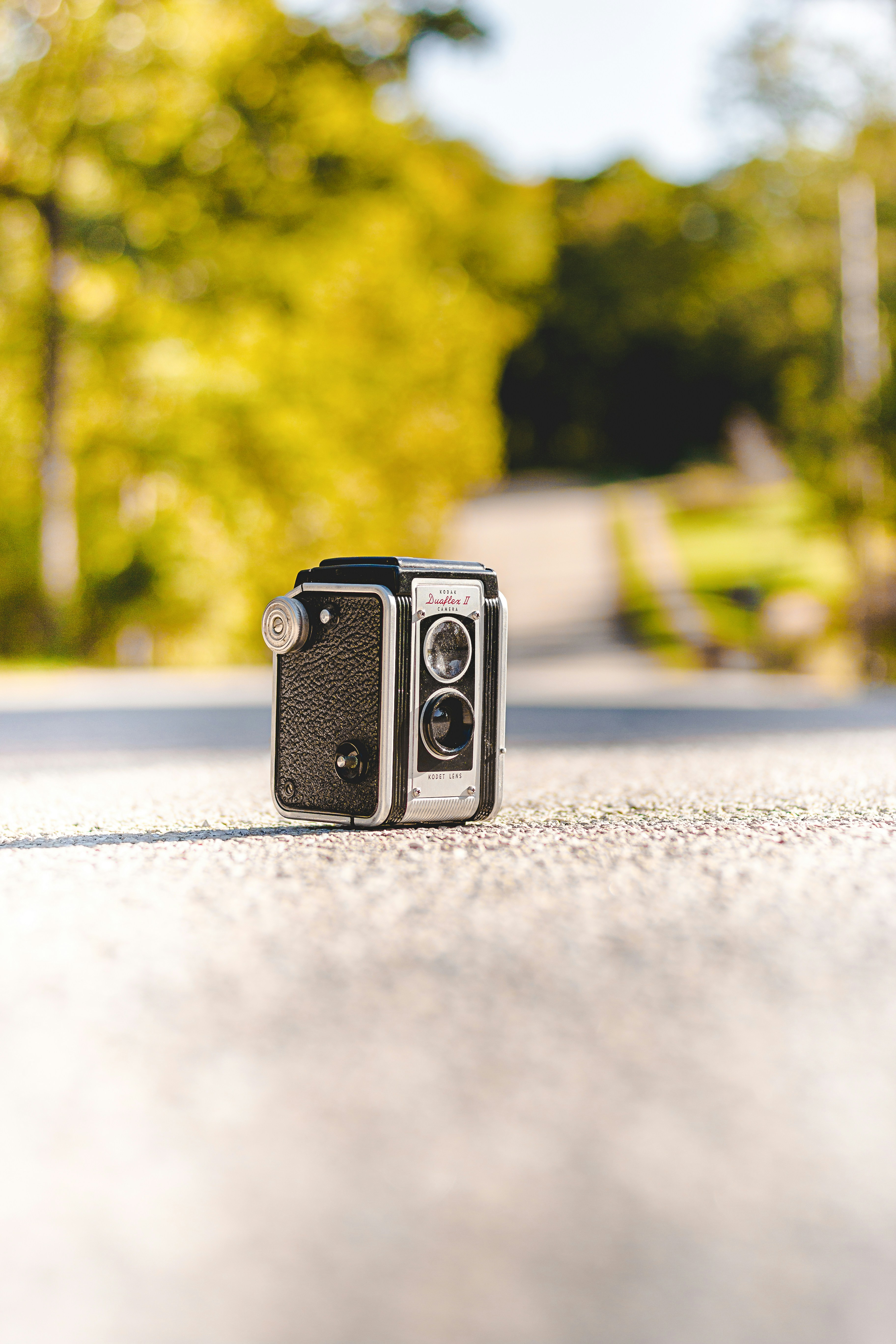 black camera on gray concrete road