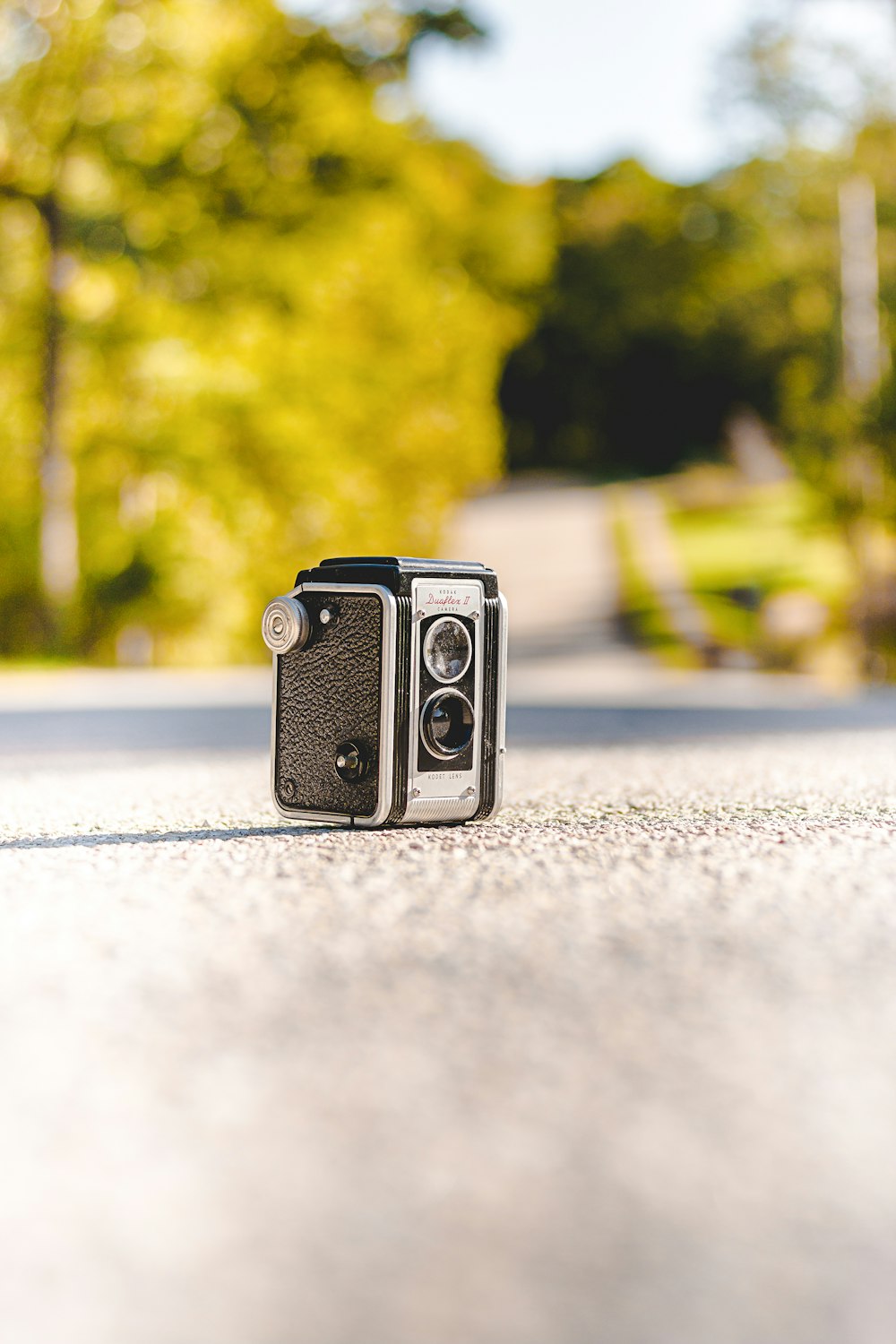 black camera on gray concrete road