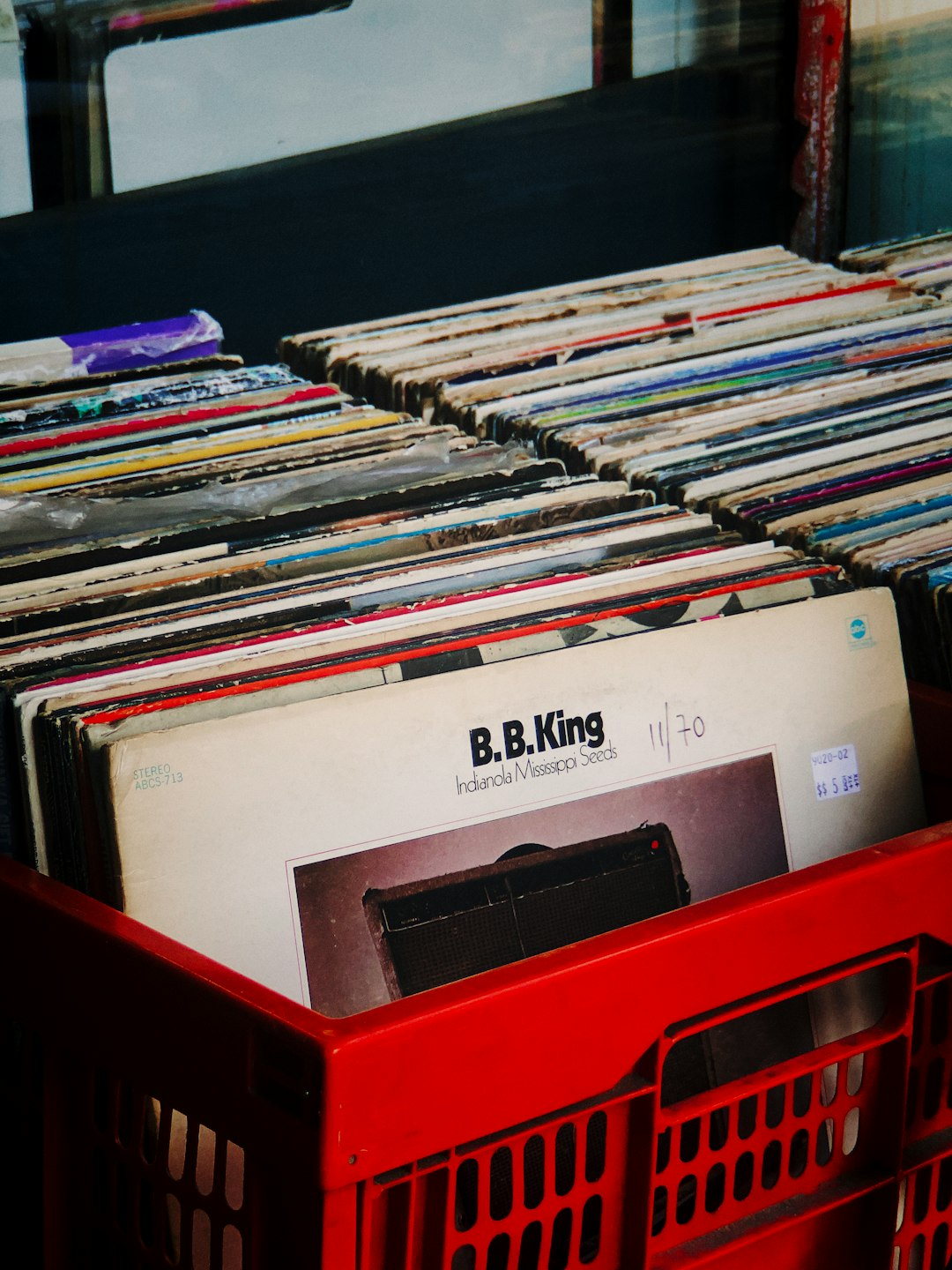 red plastic crate with books