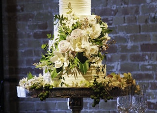 white roses on clear glass vase