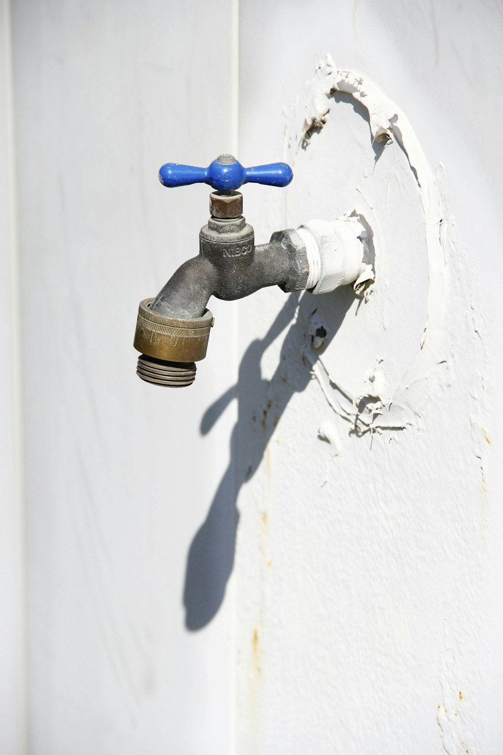 brown and black pipe on white wall