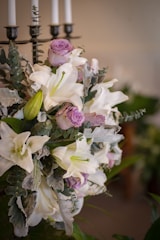 A stunning wedding floral arrangement featuring roses and lilies.