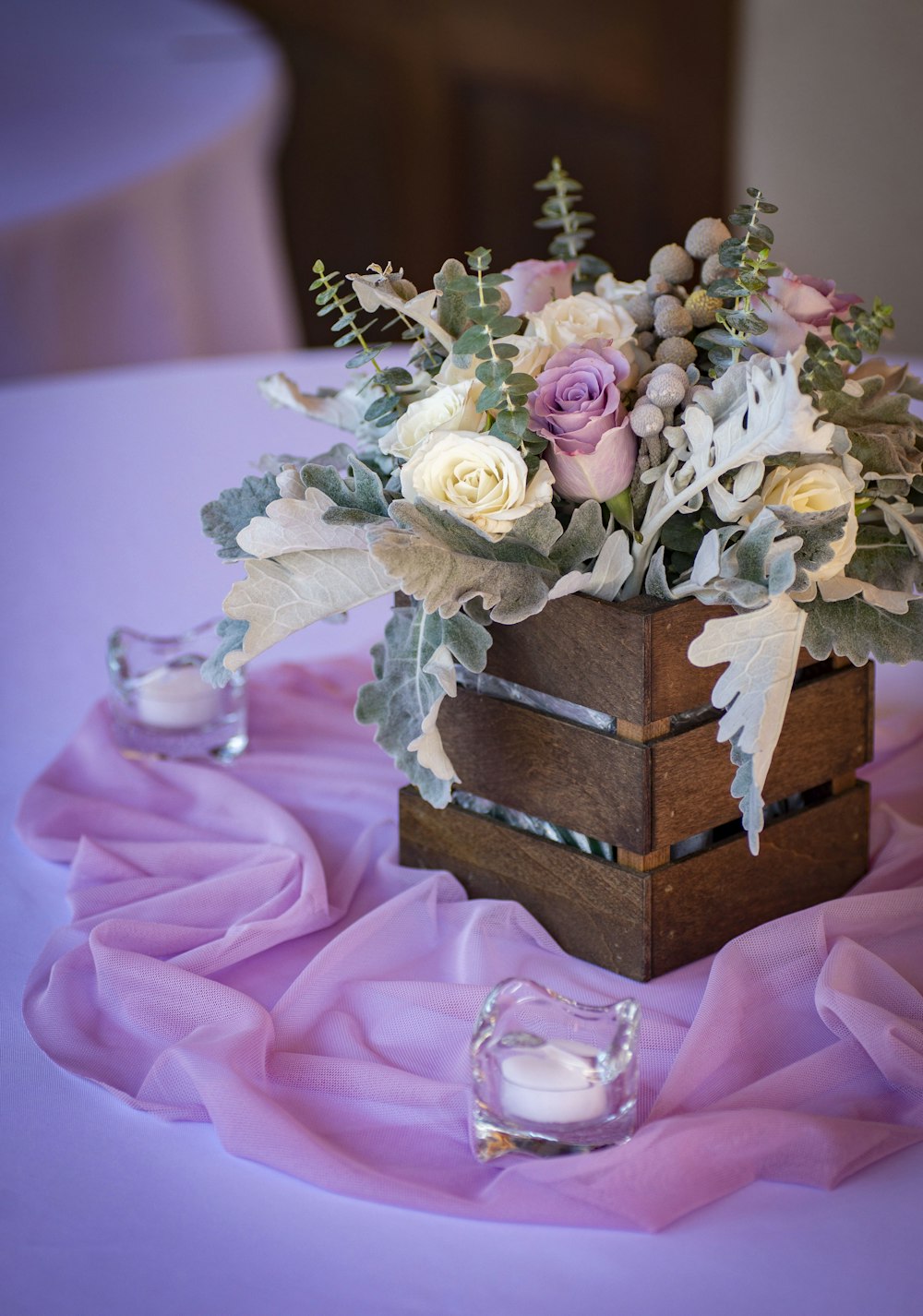 pink and white roses in brown and blue box