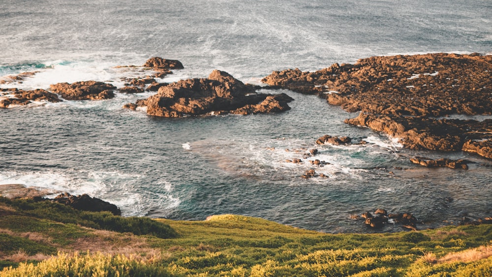 brown rock formation on sea during daytime