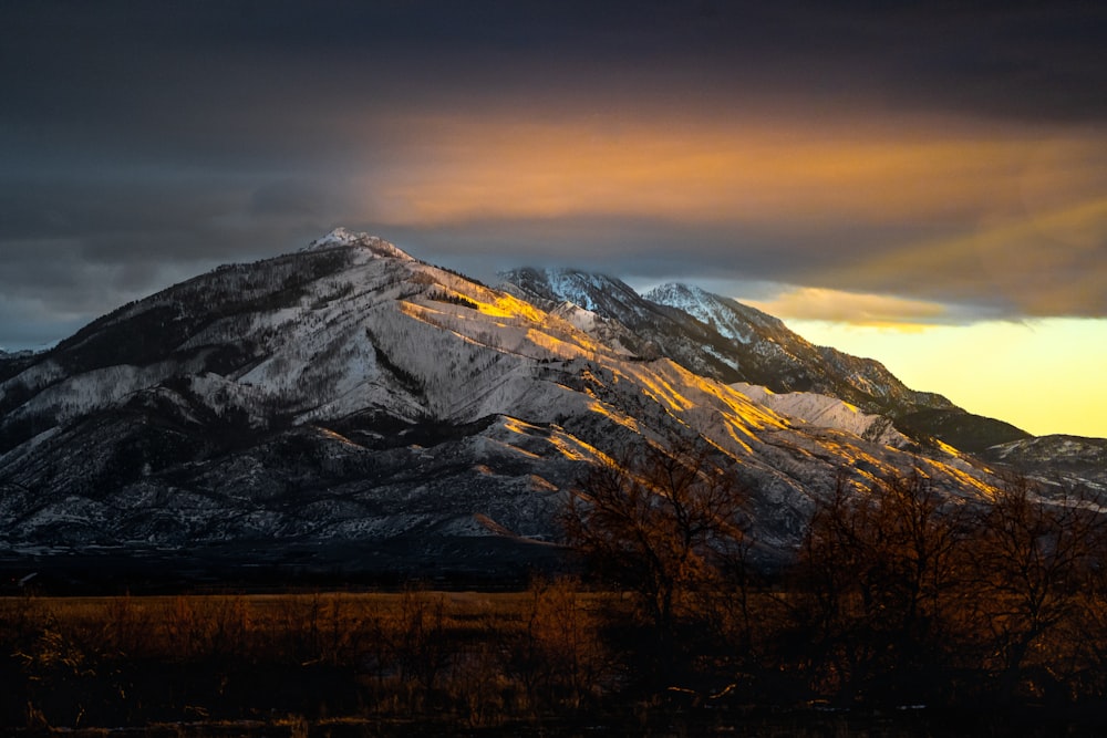 brown and white mountain under white clouds during daytime