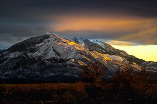 brown and white mountain under white clouds during daytime in Wasatch Mountains United States