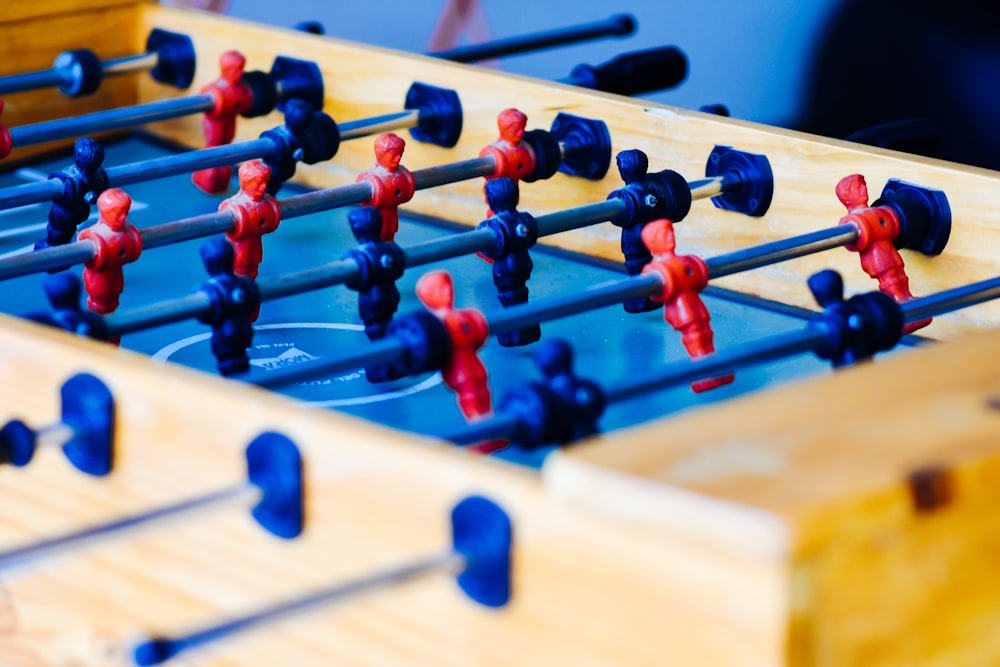 red and black chess pieces on brown wooden chess board