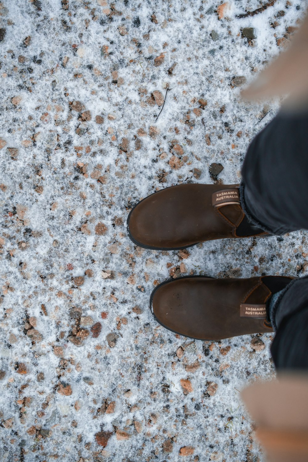 person wearing brown leather shoes