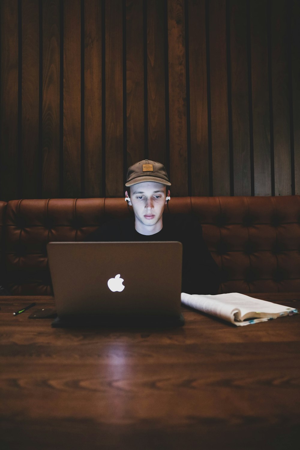 man in black jacket using macbook