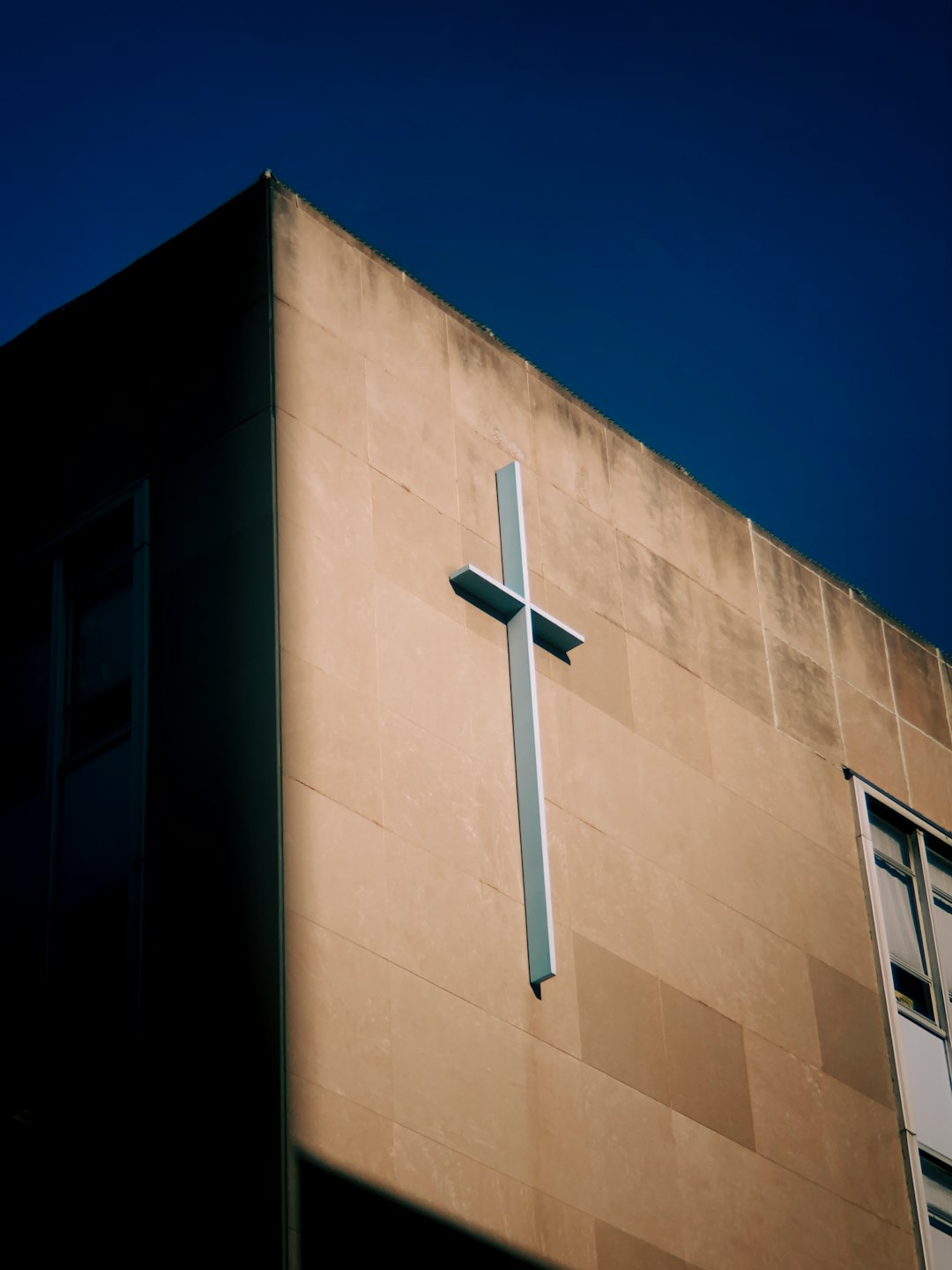 white cross on brown concrete building