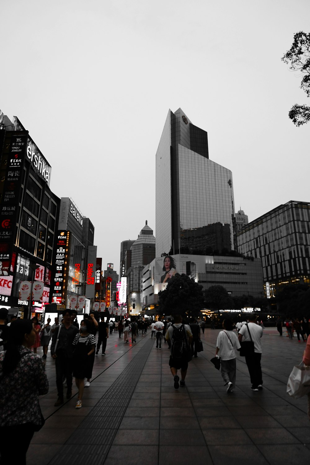 people walking on pedestrian lane near high rise buildings during daytime