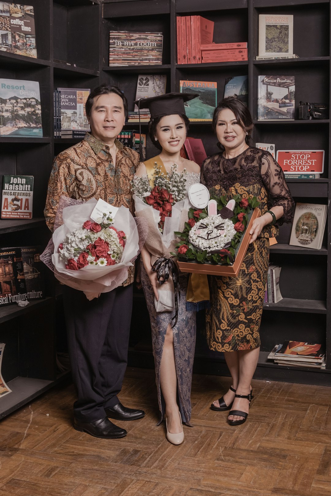 2 women holding bouquet of flowers