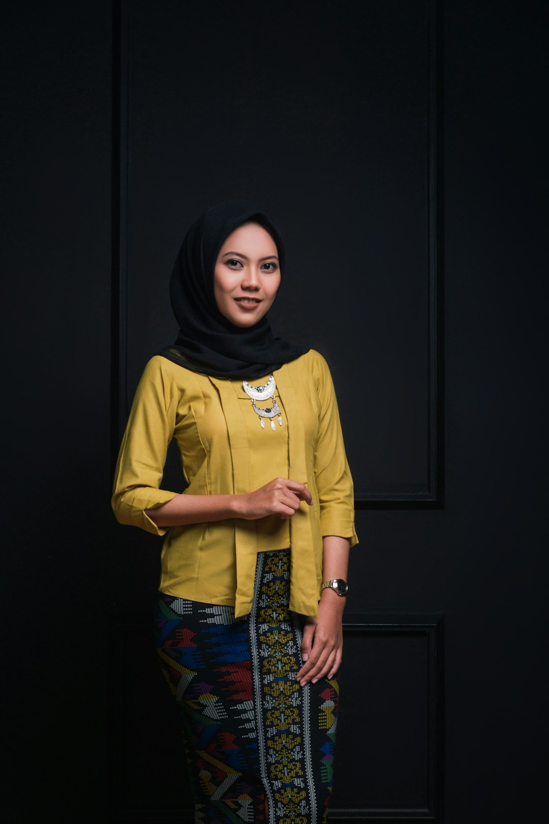 woman in yellow long sleeve shirt and black hijab