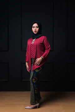 A cozy autumn outfit featuring a long skirt, oversized sweater, and a patterned hijab.