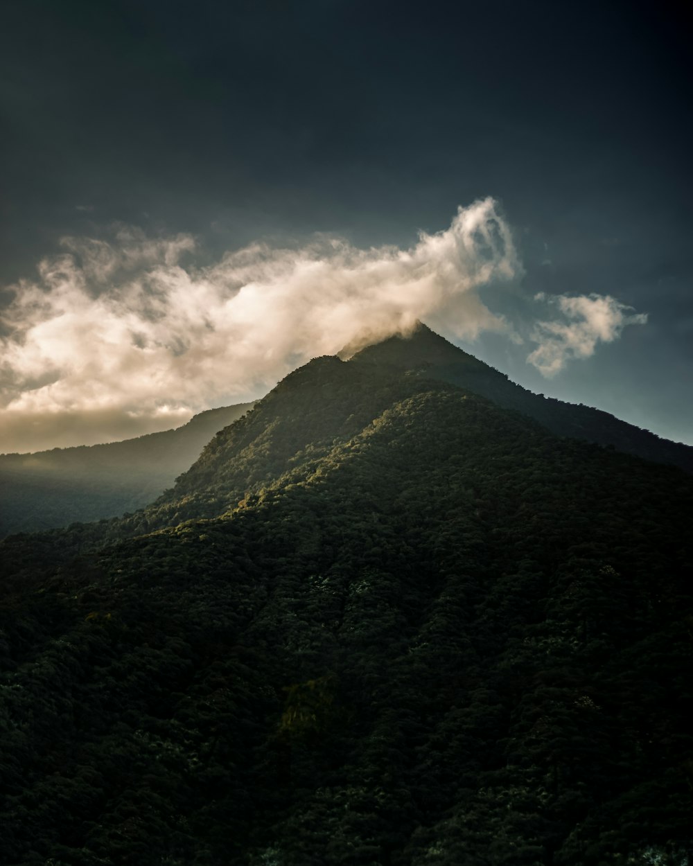 green mountain under white clouds during daytime