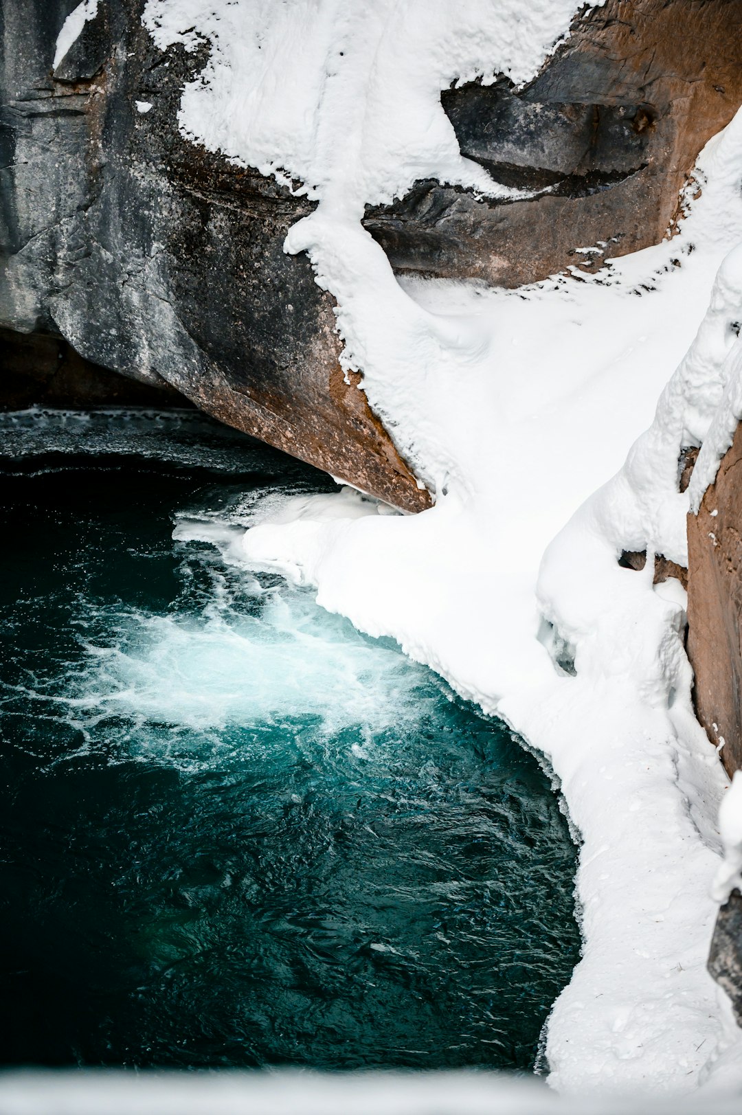 white ice on brown rock formation