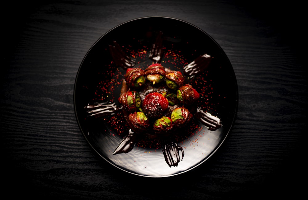 sliced strawberries on black ceramic plate