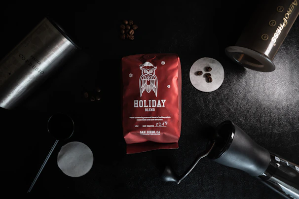 Handcrafted coffee gift basket featuring bags of coffee and brewing tools arranged on a wooden surface