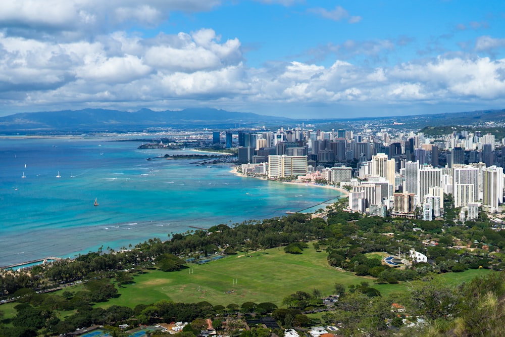 aerial view of city buildings near body of water during daytime