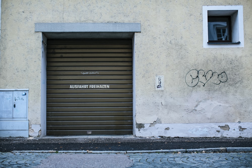 gray wooden door with black steel door