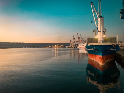 Evening view of a cargo vessel moored at a quiet riverside port.