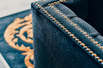Close-up of a craftsman’s hands carefully upholstering a luxurious sofa.