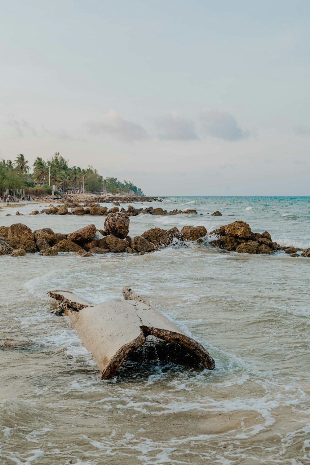 brown rock formation on sea during daytime