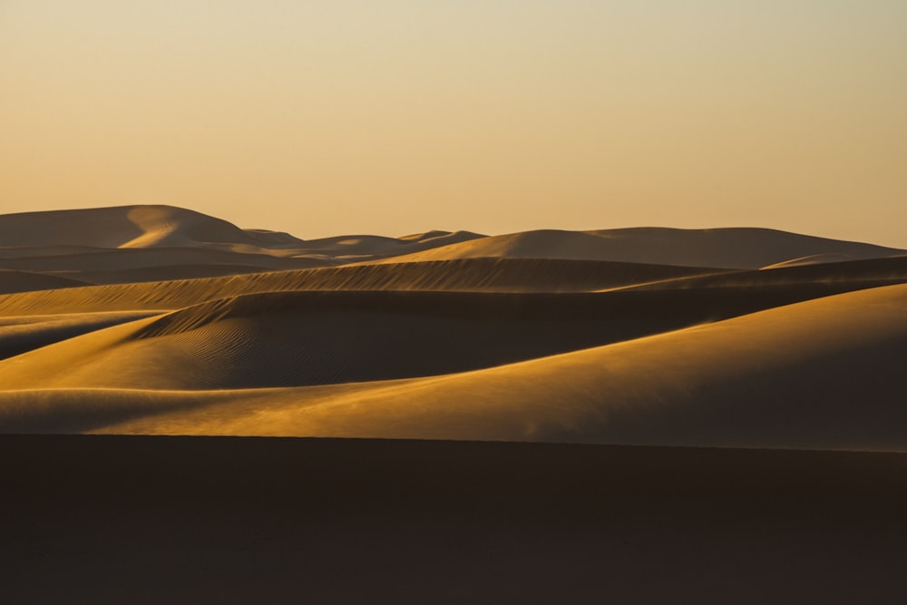 brown sand under white sky during daytime