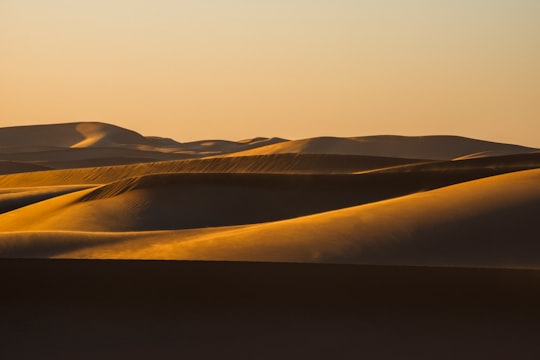 brown sand under white sky during daytime in Abu Dhabi - United Arab Emirates United Arab Emirates