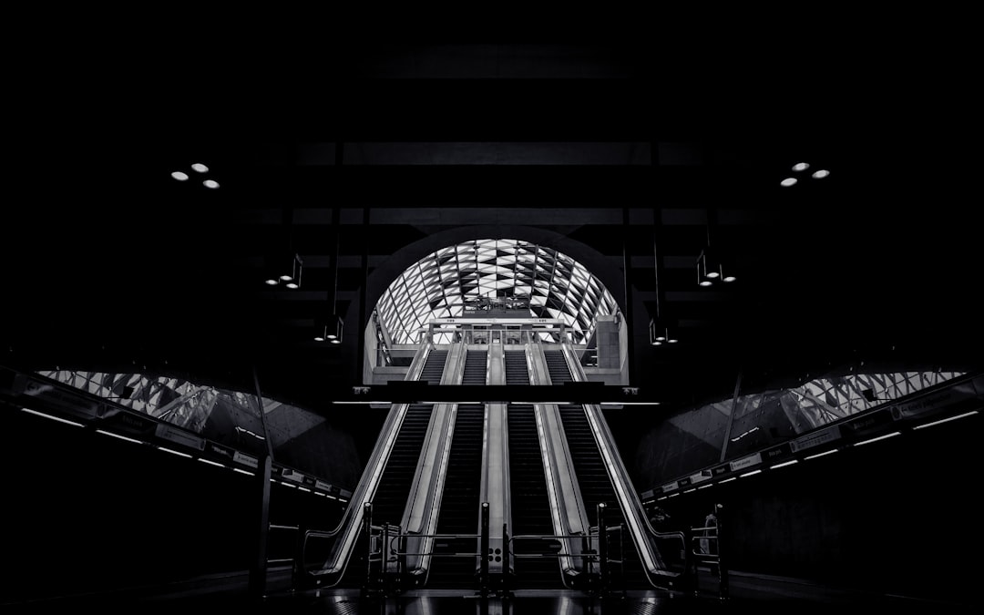 grayscale photo of a escalator