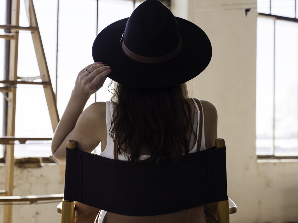 woman in black fedora hat