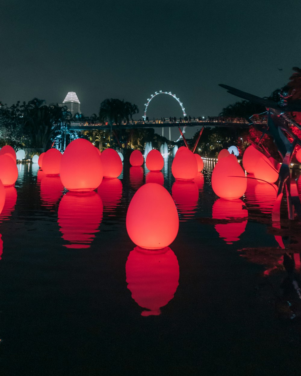 people walking on street with balloons during night time