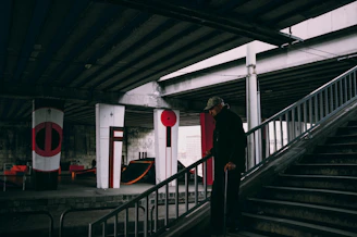 An elderly person smiling confidently while using an easystep assisted device to climb stairs at home.