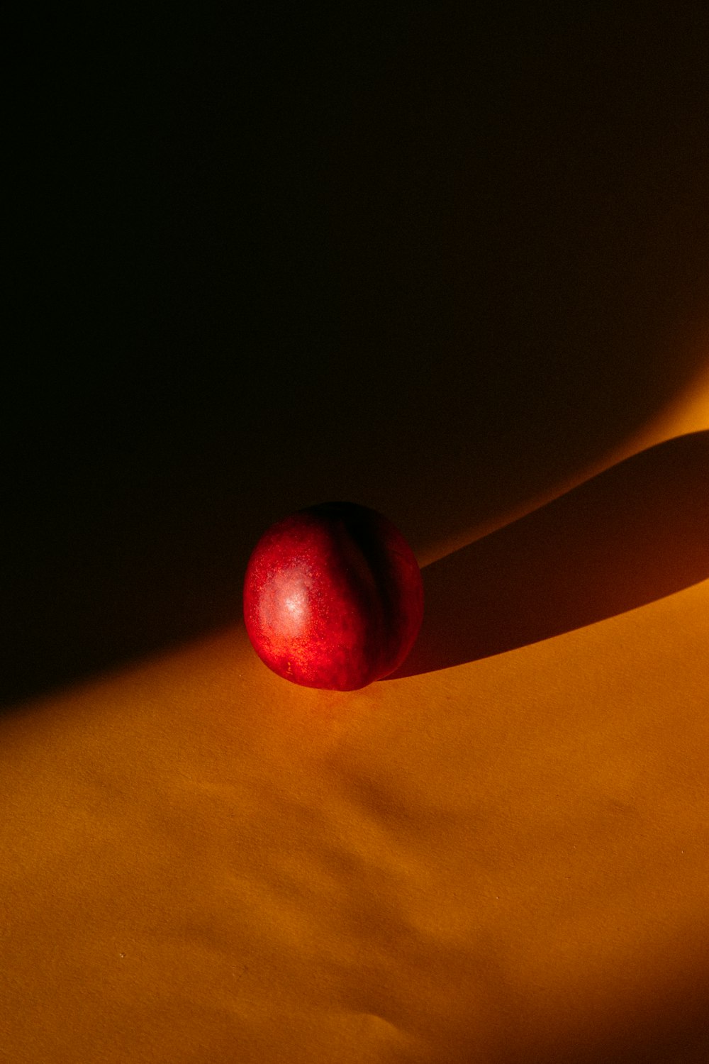 red apple fruit on yellow textile