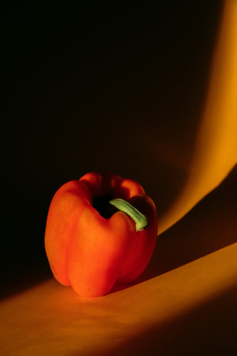 red bell pepper on yellow surface