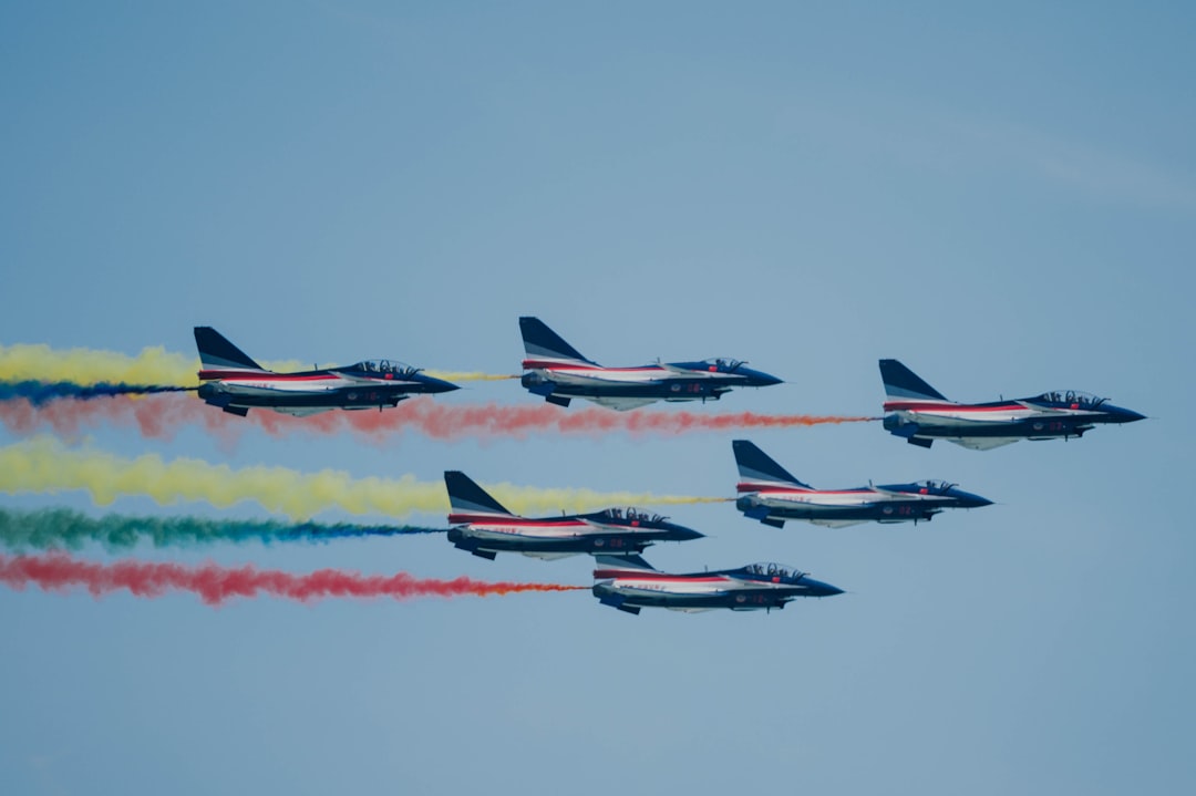 four red and gray fighter plane in mid air