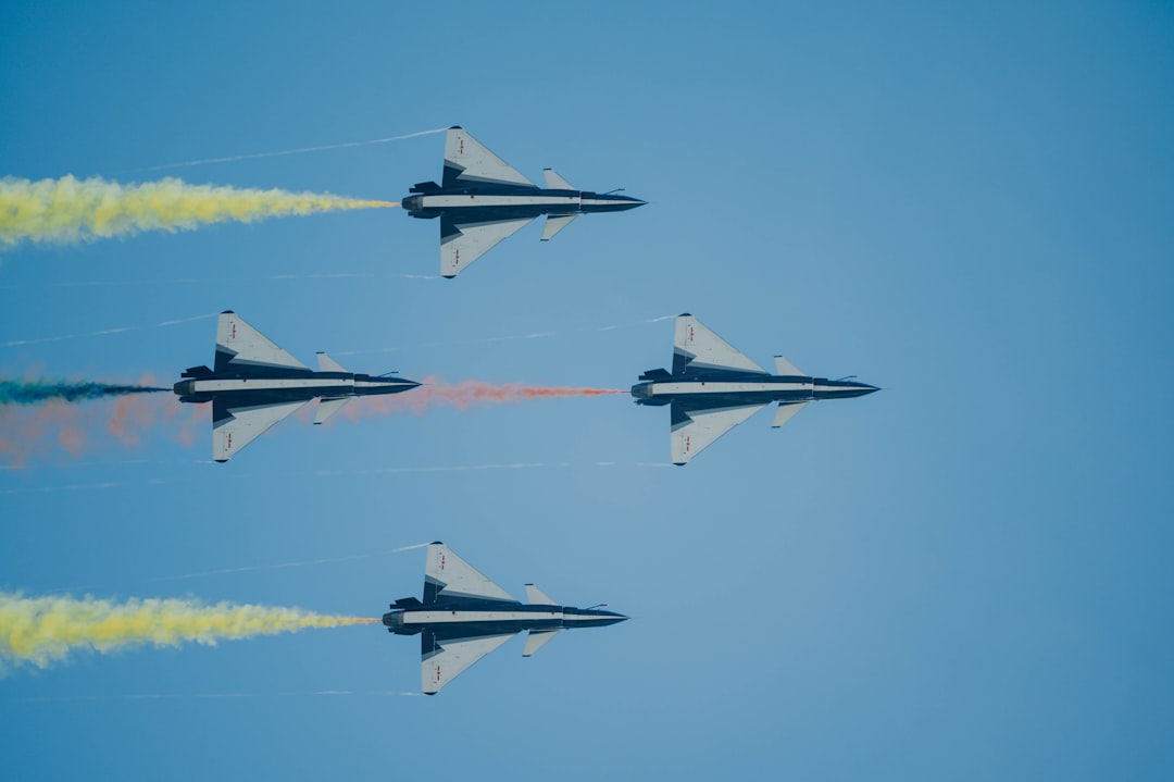 four fighter planes flying in the sky