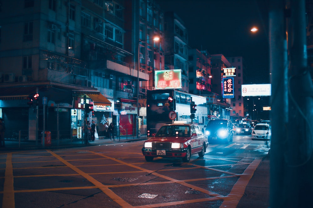 red car on the street during night time