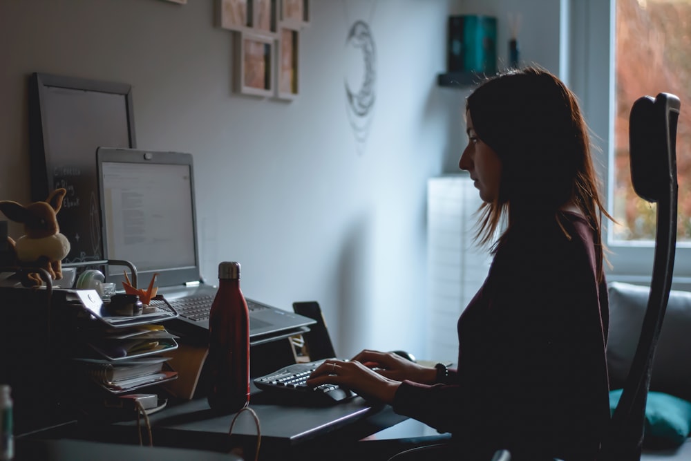 woman in black long sleeve shirt using computer