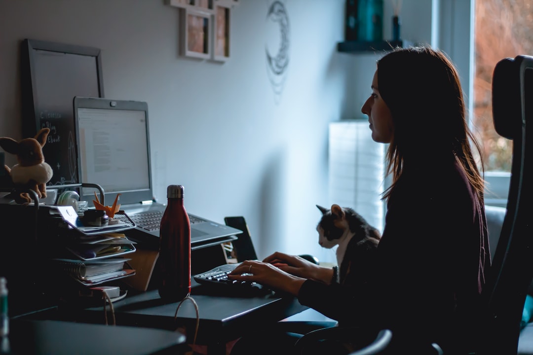 woman in black long sleeve shirt using laptop computer