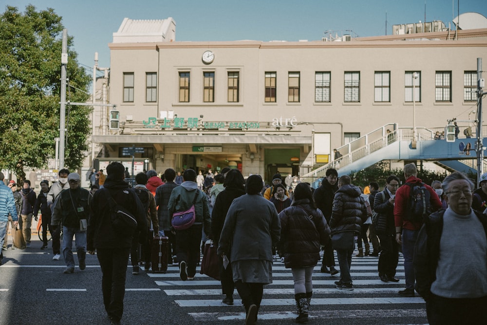 people in black coat standing on gray concrete road during daytime